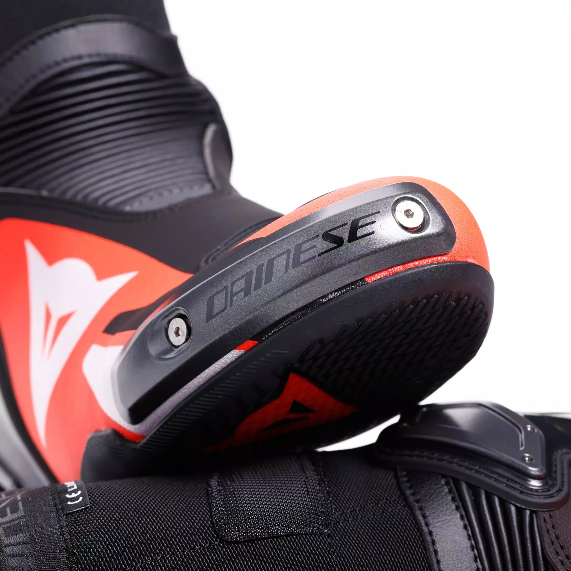 Black and red Dainese Axial 2 racing motorcycle boots with protective features, designed for high-performance riding.